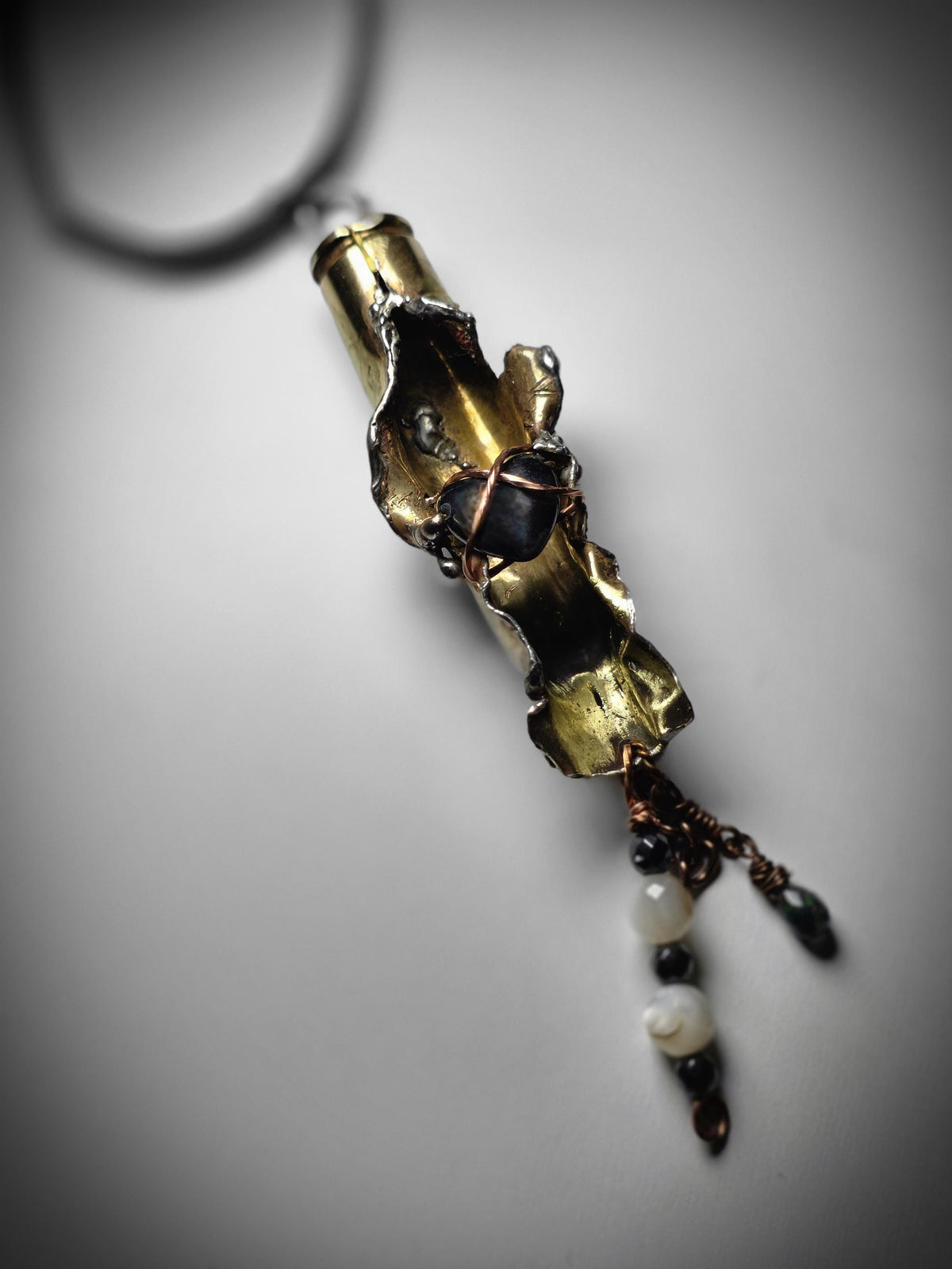 UNBROKEN “Center Mass” Shell Casing Pendant – Hematite Heart Necklace, Raw Metal Talisman, Survivor Jewelry, Rugged Artisan Pendant