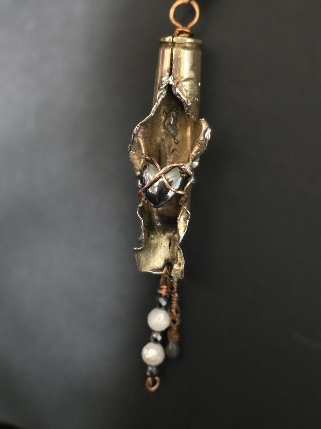 UNBROKEN “Center Mass” Shell Casing Pendant – Hematite Heart Necklace, Raw Metal Talisman, Survivor Jewelry, Rugged Artisan Pendant
