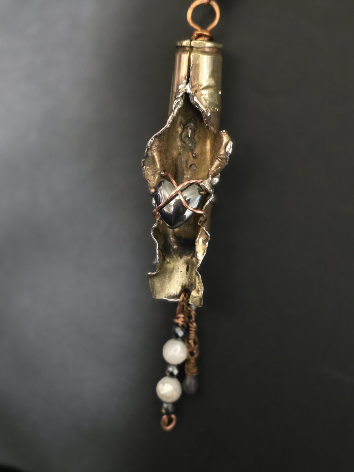 UNBROKEN “Center Mass” Shell Casing Pendant – Hematite Heart Necklace, Raw Metal Talisman, Survivor Jewelry, Rugged Artisan Pendant