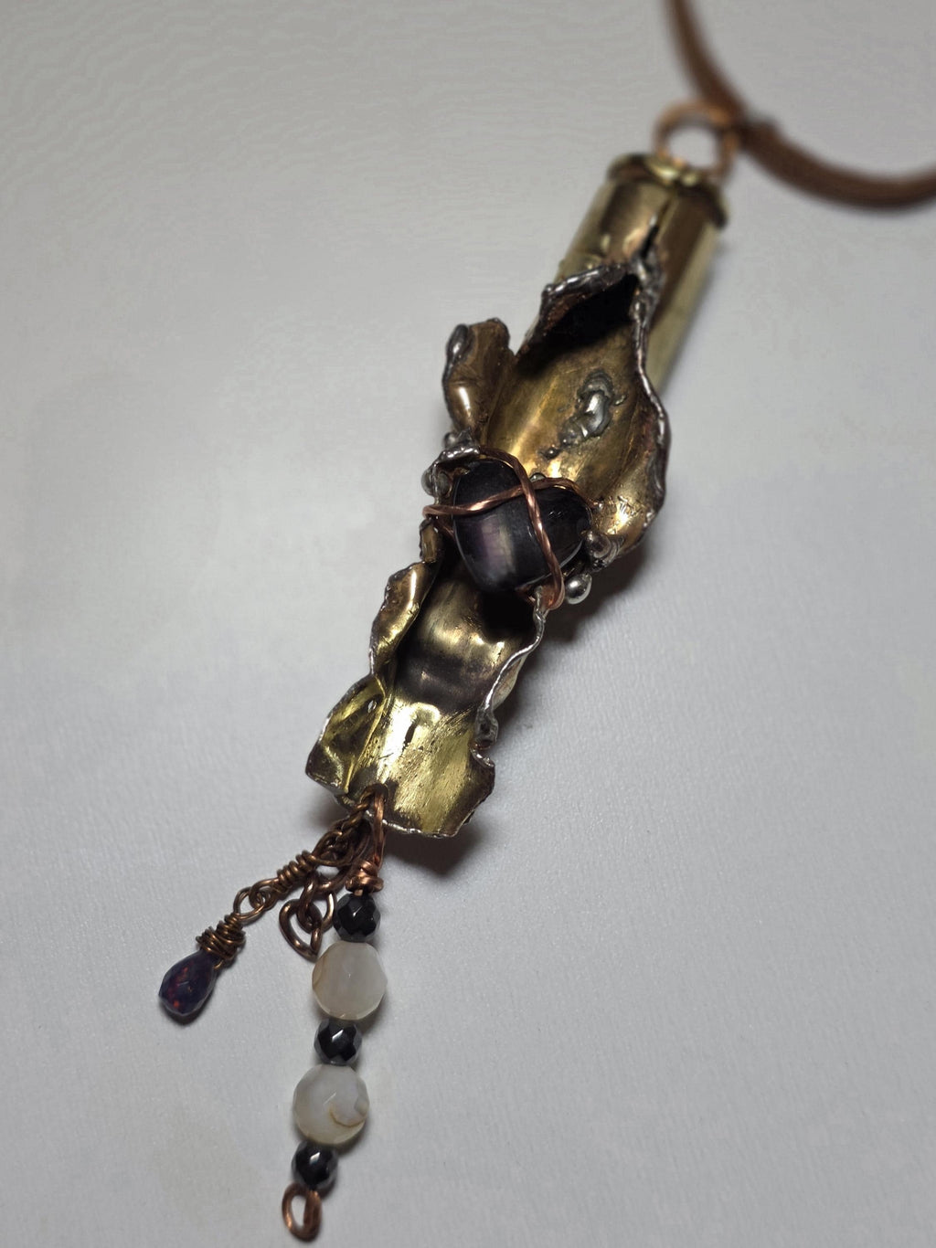 UNBROKEN “Center Mass” Shell Casing Pendant – Hematite Heart Necklace, Raw Metal Talisman, Survivor Jewelry, Rugged Artisan Pendant