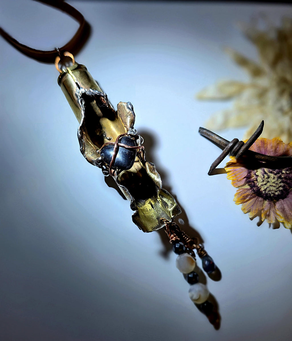 UNBROKEN “Center Mass” Shell Casing Pendant – Hematite Heart Necklace, Raw Metal Talisman, Survivor Jewelry, Rugged Artisan Pendant