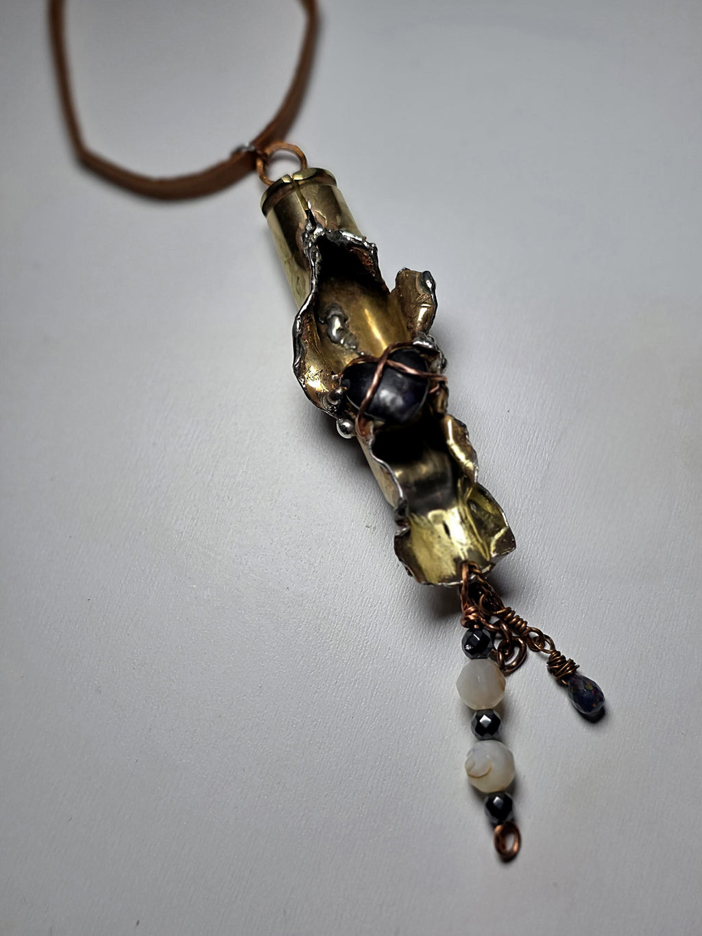 UNBROKEN “Center Mass” Shell Casing Pendant – Hematite Heart Necklace, Raw Metal Talisman, Survivor Jewelry, Rugged Artisan Pendant