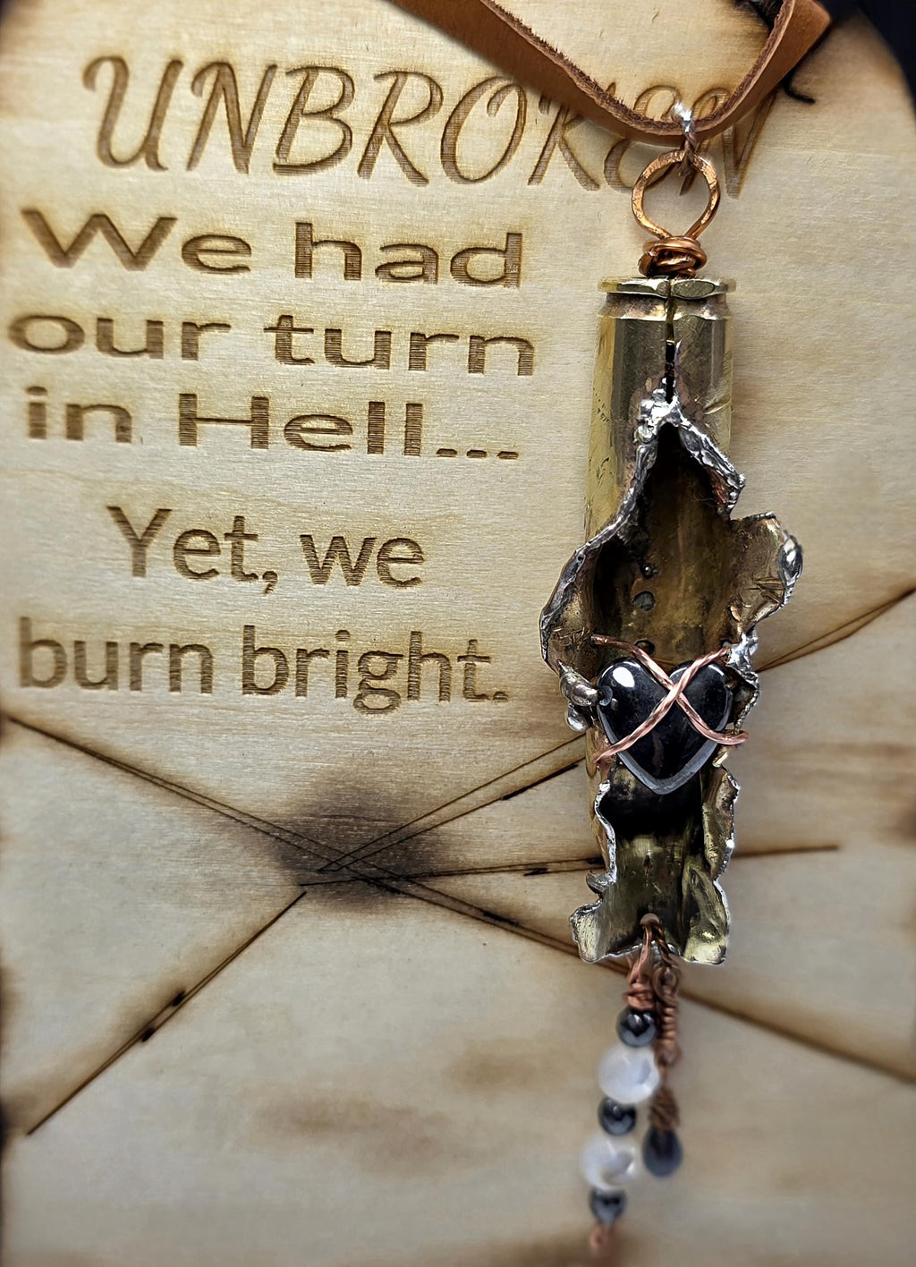 UNBROKEN “Center Mass” Shell Casing Pendant – Hematite Heart Necklace, Raw Metal Talisman, Survivor Jewelry, Rugged Artisan Pendant