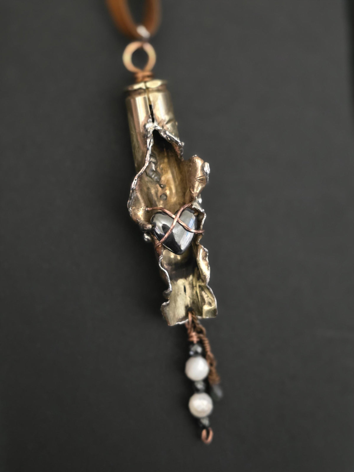 UNBROKEN “Center Mass” Shell Casing Pendant – Hematite Heart Necklace, Raw Metal Talisman, Survivor Jewelry, Rugged Artisan Pendant